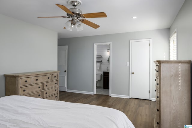 bedroom with ceiling fan, dark hardwood / wood-style flooring, and ensuite bath