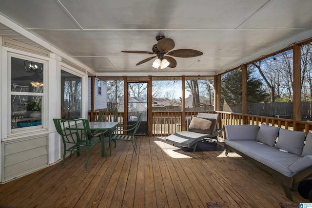 sunroom / solarium featuring ceiling fan