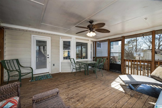 sunroom / solarium featuring ceiling fan