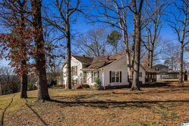 view of side of property with a lawn