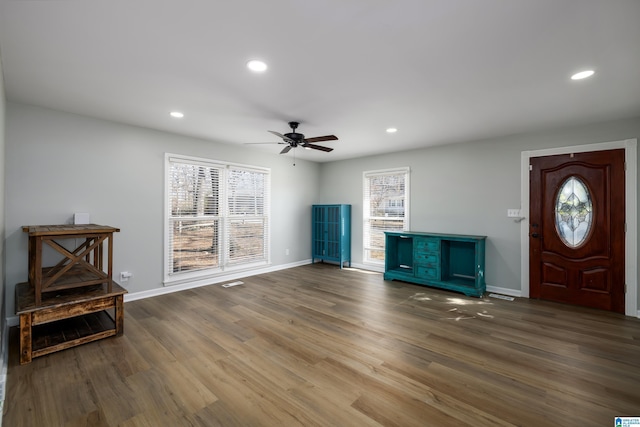 interior space with ceiling fan and dark wood-type flooring