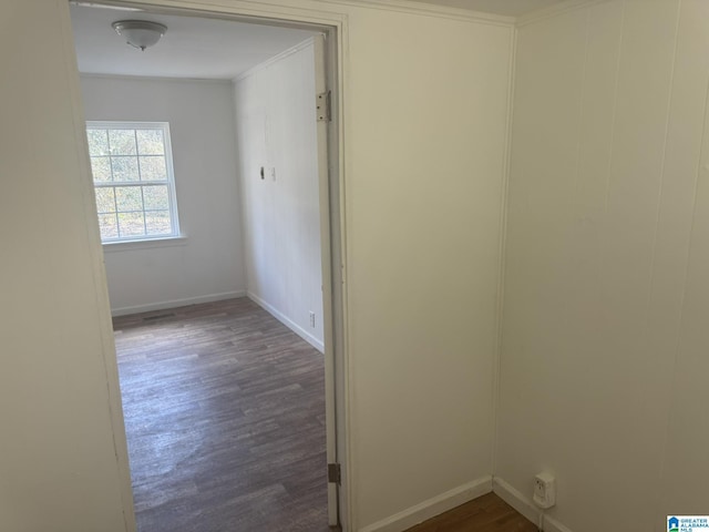 empty room featuring ornamental molding and dark hardwood / wood-style floors