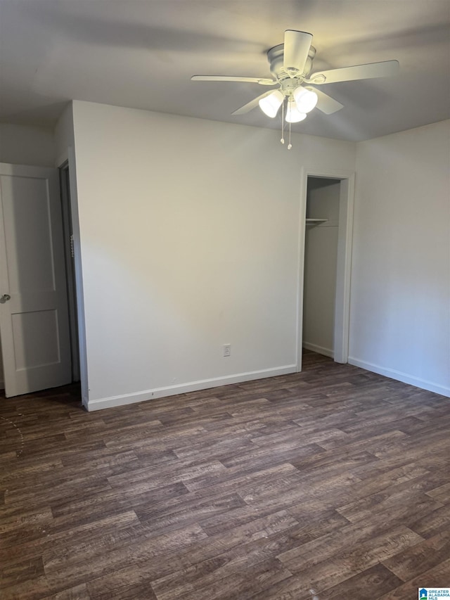 unfurnished bedroom featuring a closet, dark hardwood / wood-style floors, and ceiling fan