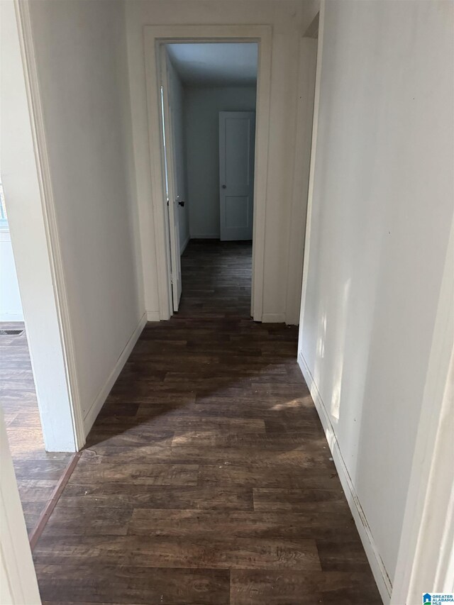 hallway with dark wood-type flooring