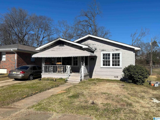 view of front of home featuring a front yard and a porch