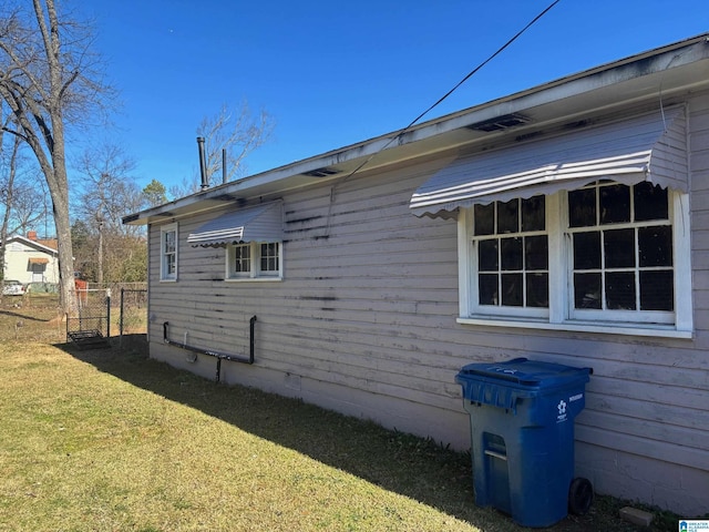 view of home's exterior with a yard