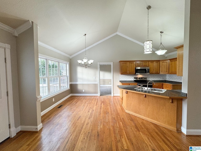 kitchen featuring a kitchen bar, kitchen peninsula, appliances with stainless steel finishes, tasteful backsplash, and vaulted ceiling