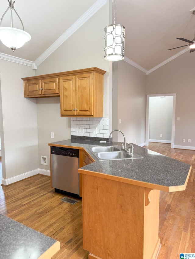 kitchen with sink, dishwasher, crown molding, and vaulted ceiling