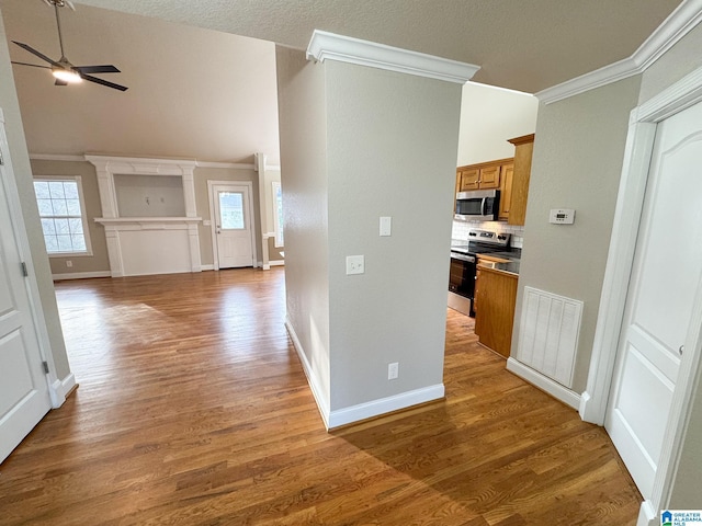 hallway with a textured ceiling, dark hardwood / wood-style floors, and crown molding