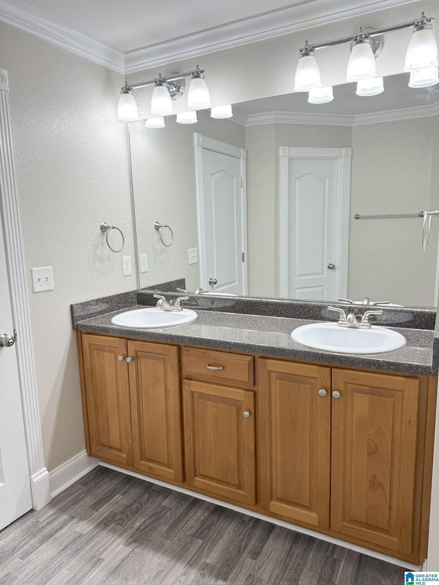 bathroom featuring hardwood / wood-style floors, vanity, and crown molding