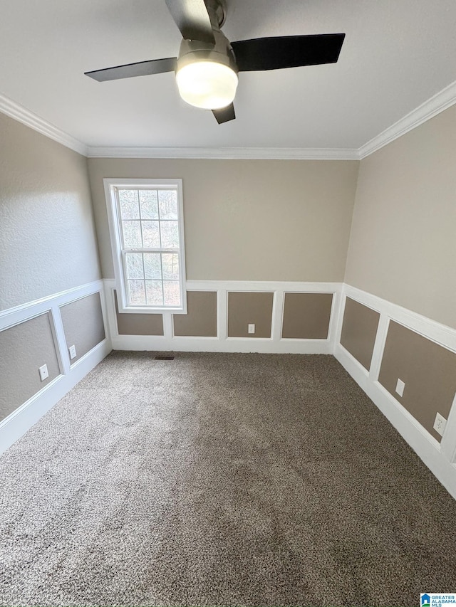 spare room with ceiling fan, carpet floors, and ornamental molding