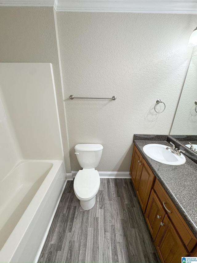 full bathroom featuring toilet, vanity, wood-type flooring, and tub / shower combination