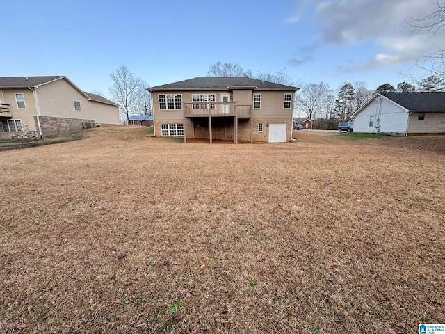 rear view of property featuring a yard and a wooden deck