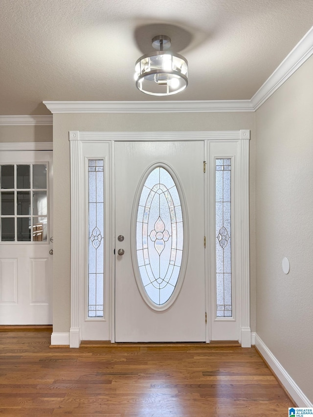 entrance foyer featuring dark hardwood / wood-style flooring and ornamental molding