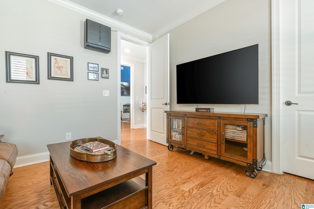 living room featuring crown molding, light hardwood / wood-style floors, and an AC wall unit