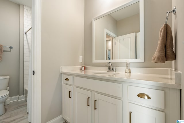 full bathroom featuring hardwood / wood-style floors, washtub / shower combination, toilet, and vanity