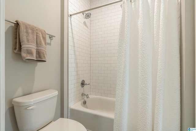 bathroom with toilet and shower / tub combo with curtain