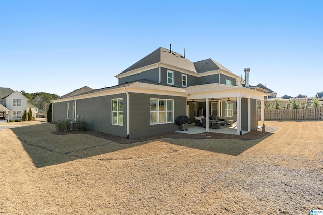 rear view of house with ceiling fan and a patio