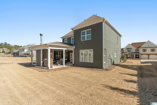 rear view of property featuring a patio and a yard