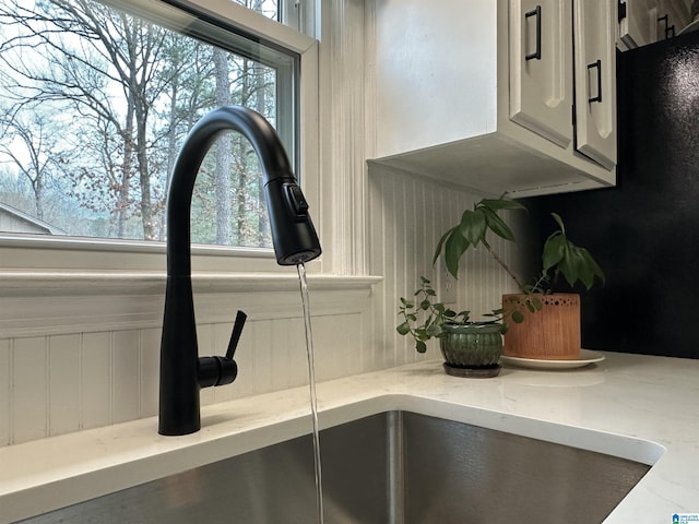 interior details with light stone countertops and sink