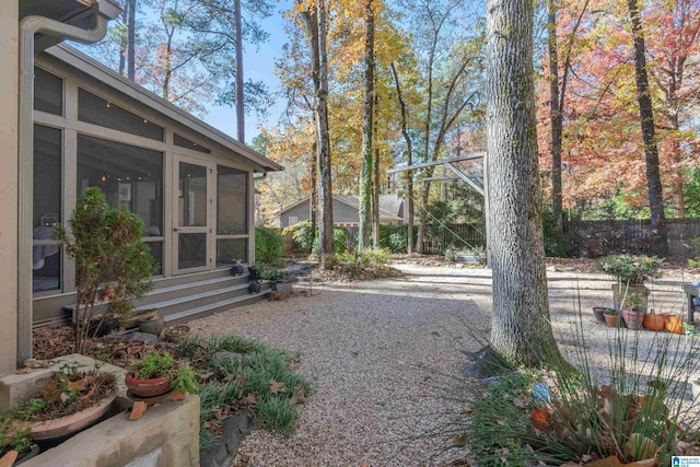 view of yard featuring a sunroom and a patio