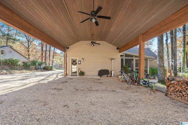 view of patio with ceiling fan and a sunroom