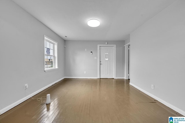 unfurnished room with hardwood / wood-style flooring