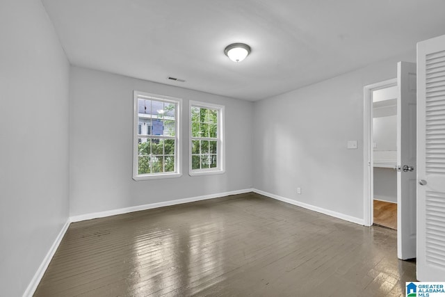 unfurnished room with dark hardwood / wood-style floors