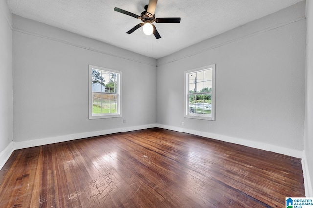 spare room featuring ceiling fan and dark hardwood / wood-style floors