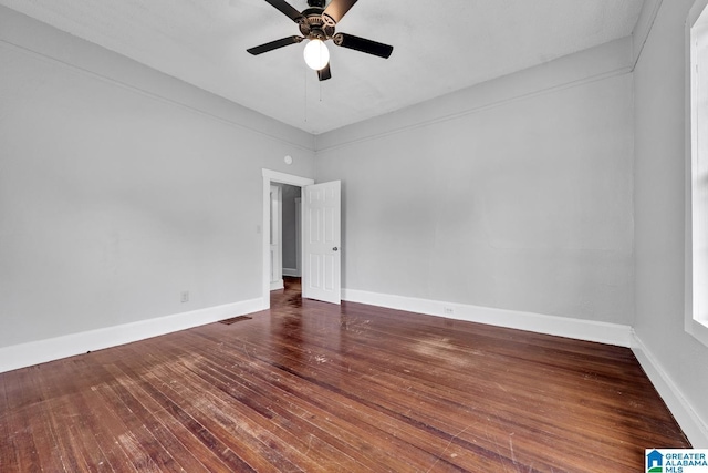 unfurnished room featuring ceiling fan and dark hardwood / wood-style floors