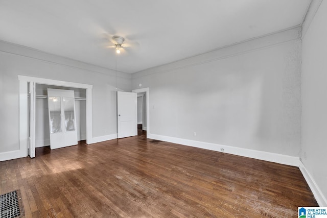 unfurnished bedroom with ceiling fan, a closet, dark hardwood / wood-style flooring, and ornamental molding