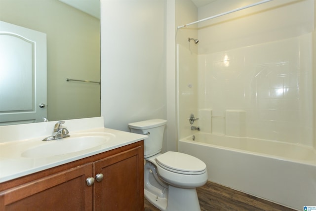 full bathroom featuring toilet, vanity, tub / shower combination, and hardwood / wood-style floors