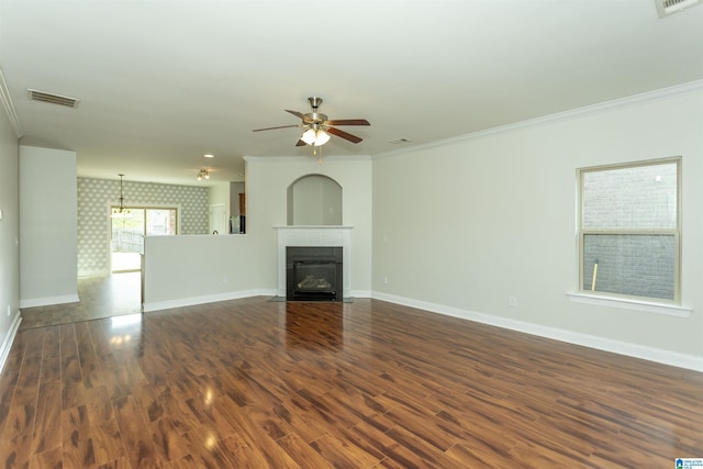 unfurnished living room featuring ceiling fan, dark hardwood / wood-style floors, and ornamental molding