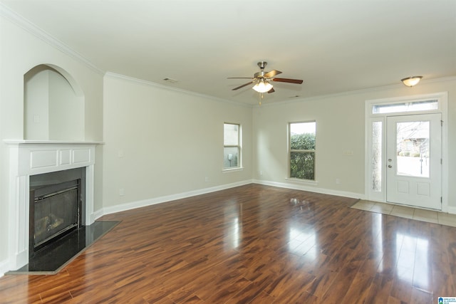 unfurnished living room with ceiling fan, ornamental molding, and dark hardwood / wood-style floors