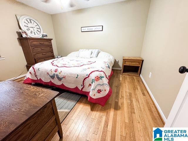 bedroom with ceiling fan and light hardwood / wood-style flooring