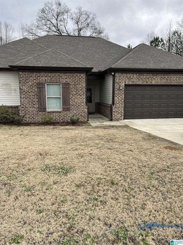 ranch-style house with a front lawn and a garage