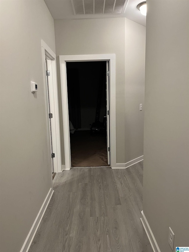 hallway with dark hardwood / wood-style flooring