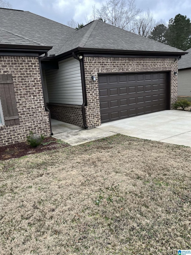 view of side of home with a yard and a garage