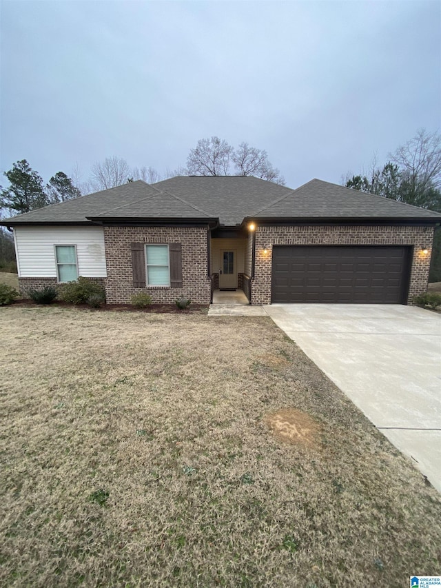 view of front of home with a front yard and a garage