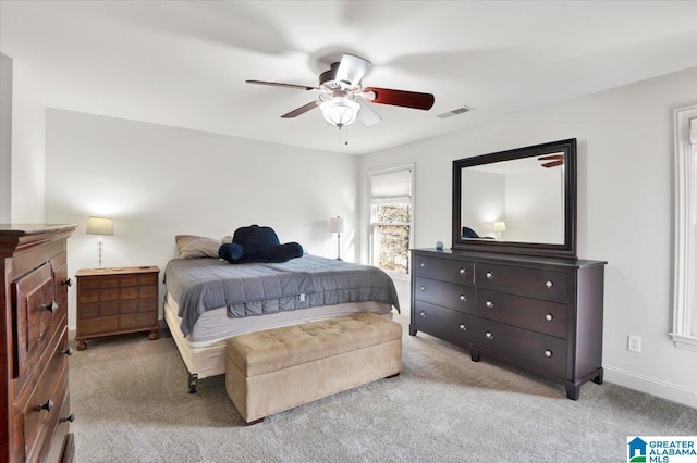 bedroom with ceiling fan and light carpet