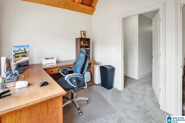 carpeted home office featuring lofted ceiling