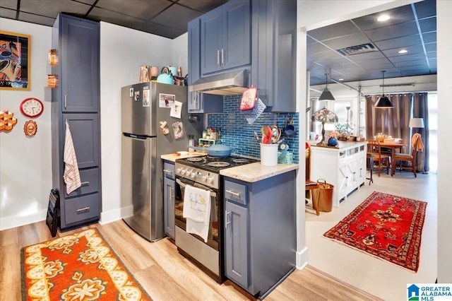 kitchen featuring stainless steel appliances, light hardwood / wood-style floors, hanging light fixtures, and a drop ceiling