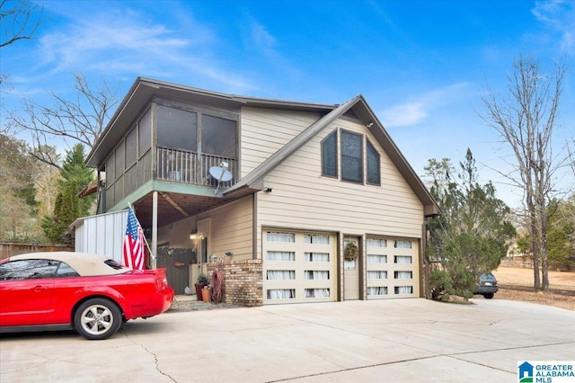 view of property exterior featuring a garage and a sunroom