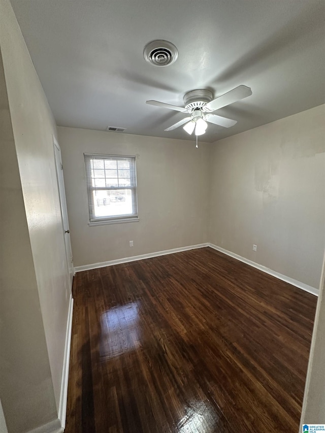 unfurnished room with ceiling fan and dark wood-type flooring