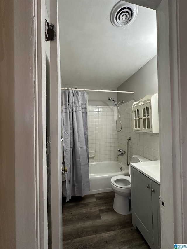 full bathroom featuring toilet, decorative backsplash, shower / bath combination with curtain, wood-type flooring, and vanity