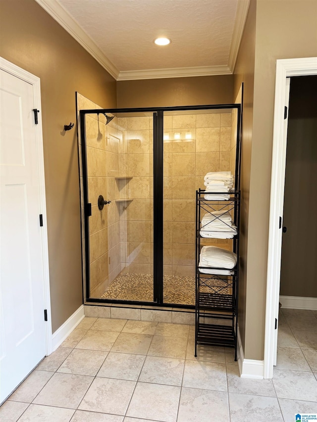 bathroom featuring a shower with door, ornamental molding, and tile patterned flooring