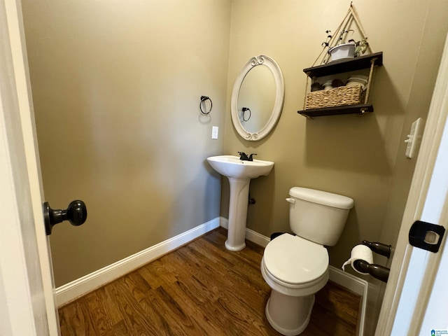 bathroom featuring toilet, sink, and hardwood / wood-style flooring