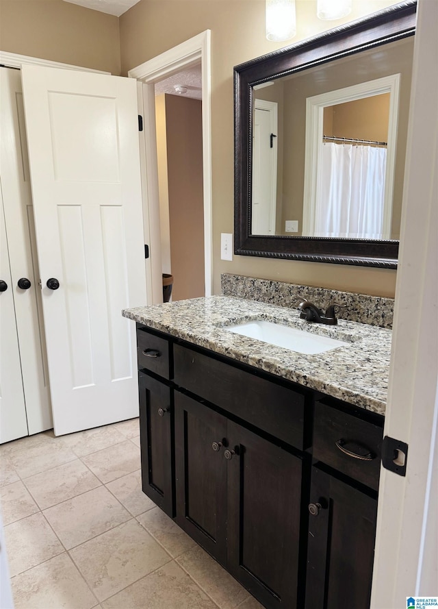 bathroom with vanity and tile patterned floors