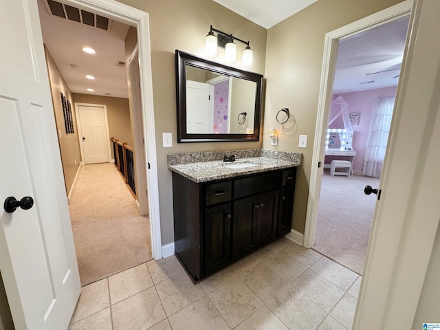 bathroom featuring tile patterned flooring and vanity