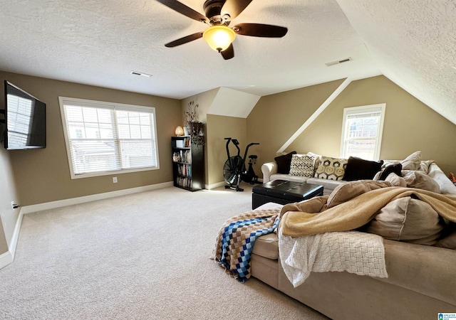 carpeted living room with ceiling fan, vaulted ceiling, and a textured ceiling